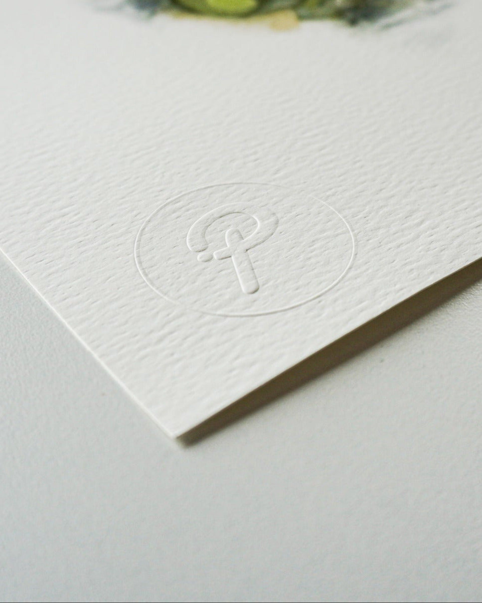 White card with embossed logo on a light gray background