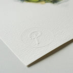 White card with embossed logo on a light gray background