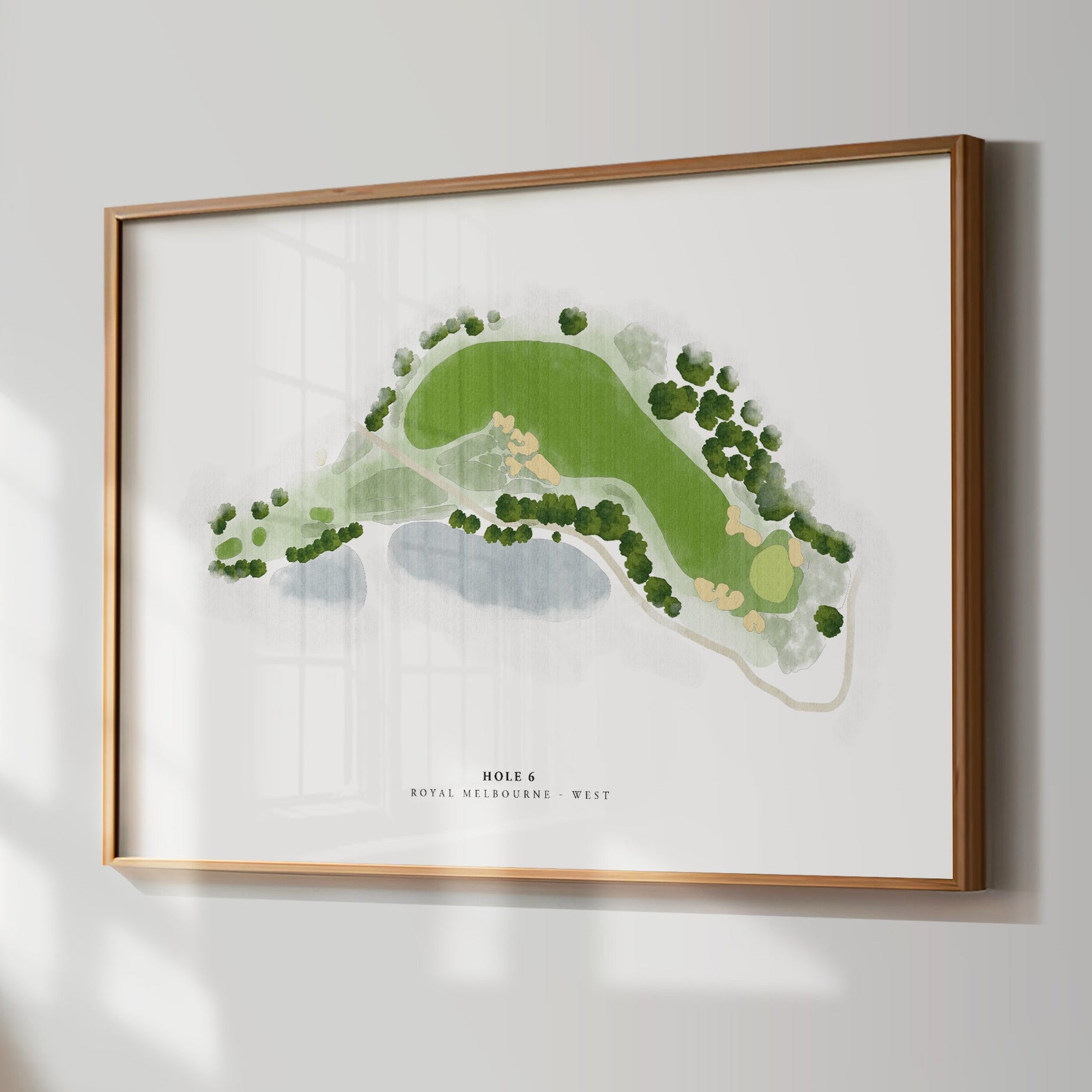 Framed golf course map on a wall in a room with a window